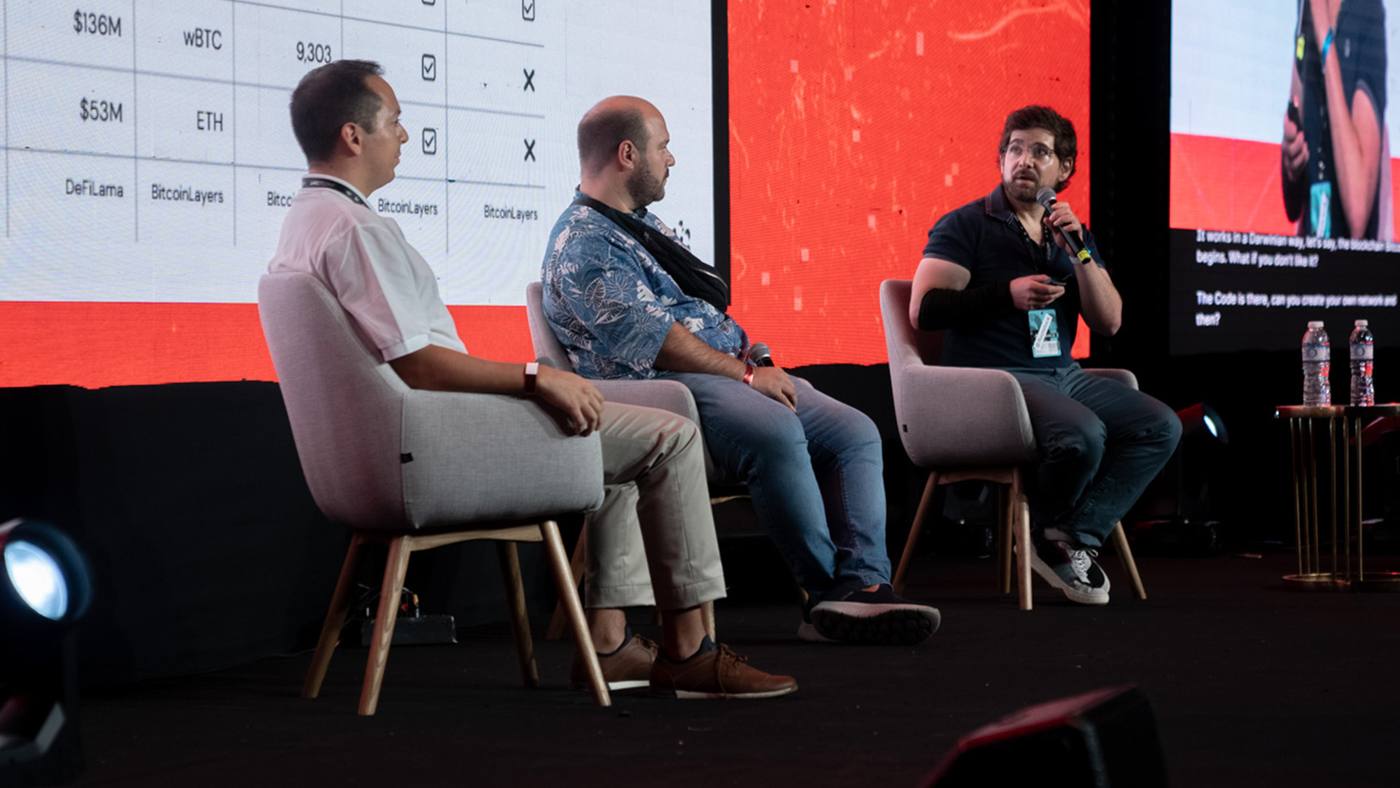Panel discussion on the LABITCONF stage with three speakers