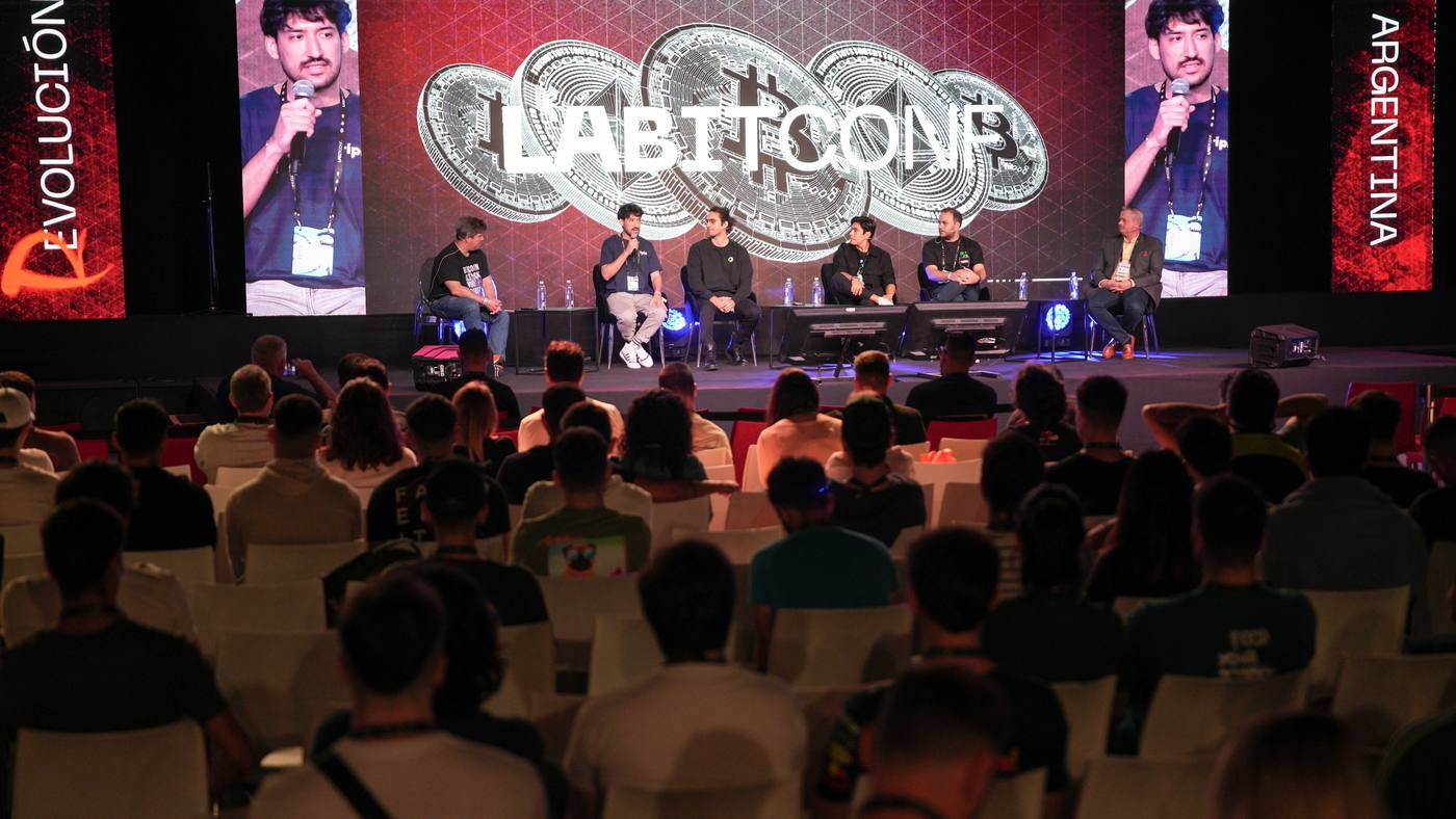 LABITCONF audience facing the main stage with the conference logo on screen